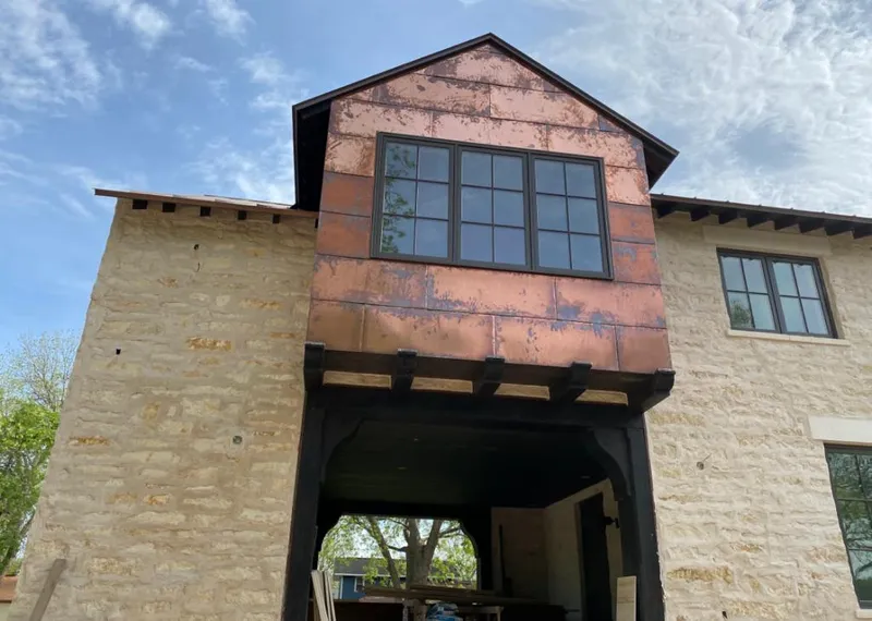 Copper metal panel facade on a stone building for Skylight Installation in Minooka