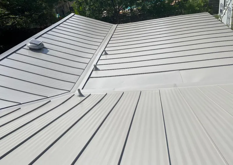 Solar attic fan installed on a metal roof for Roof Ventilation in Minooka